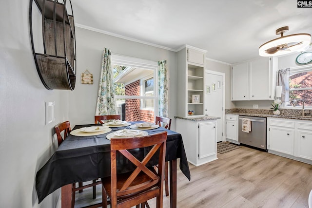 kitchen featuring white cabinets, light wood-style flooring, stainless steel dishwasher, and open shelves