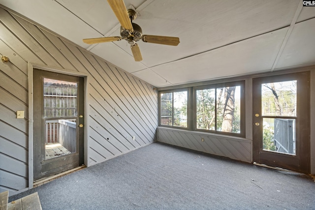 unfurnished sunroom with ceiling fan