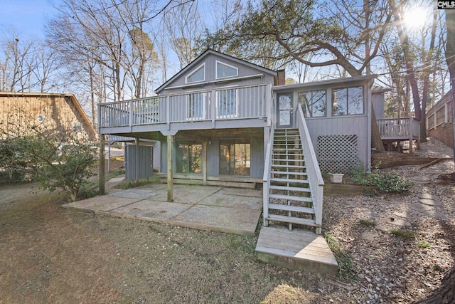 rear view of property with a deck, a patio, and stairway