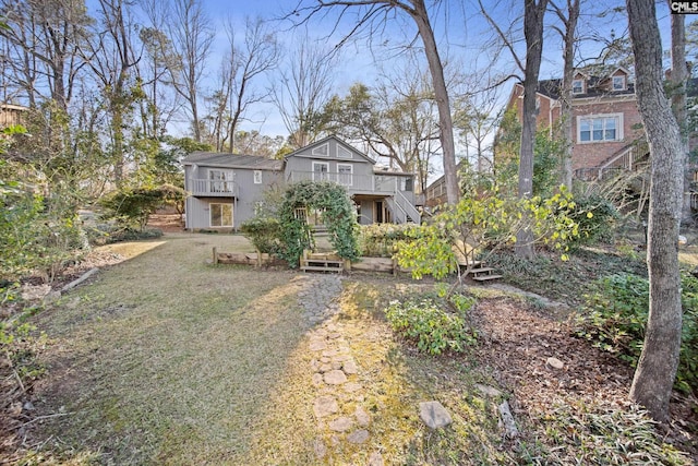 rear view of house featuring stairway and a wooden deck