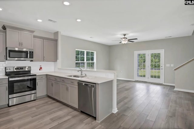 1233 Turtle Stone Rd, Blythewood, SC 29016 - kitchen featuring stainless steel appliances, gray cabinets, a sink, a peninsula, and a ceiling fan