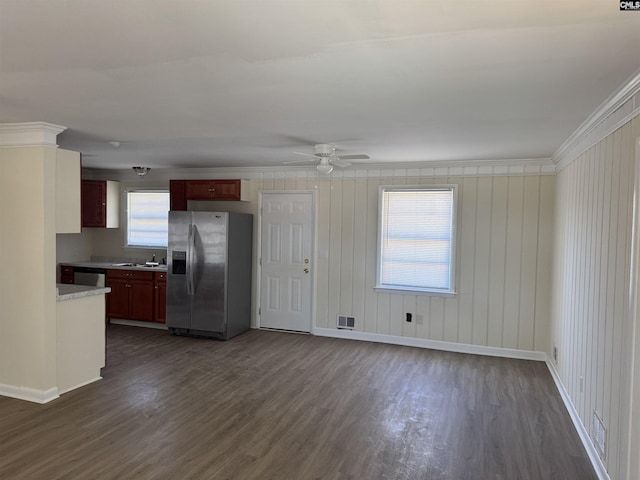 kitchen featuring stainless steel appliances, ornamental molding, and dark wood-style floors