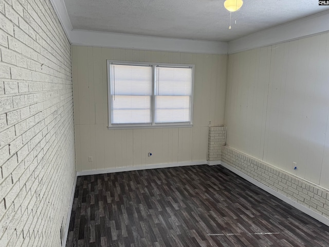 empty room with baseboards, dark wood finished floors, and a textured ceiling