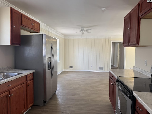 kitchen featuring light countertops, visible vents, appliances with stainless steel finishes, dark wood-type flooring, and a ceiling fan