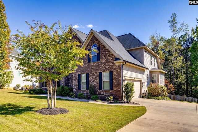 view of front facade featuring brick siding, a shingled roof, fence, driveway, and a front lawn