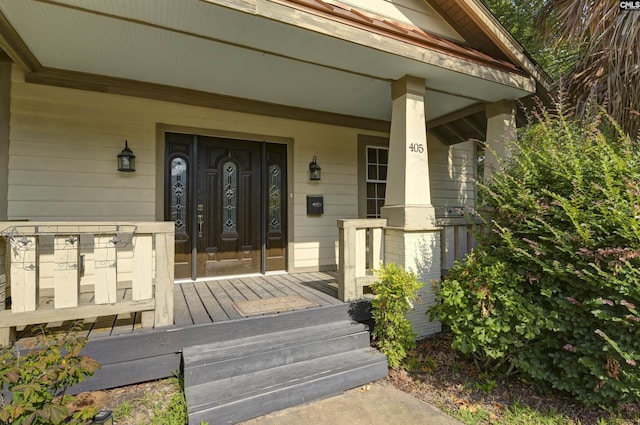 view of exterior entry with covered porch