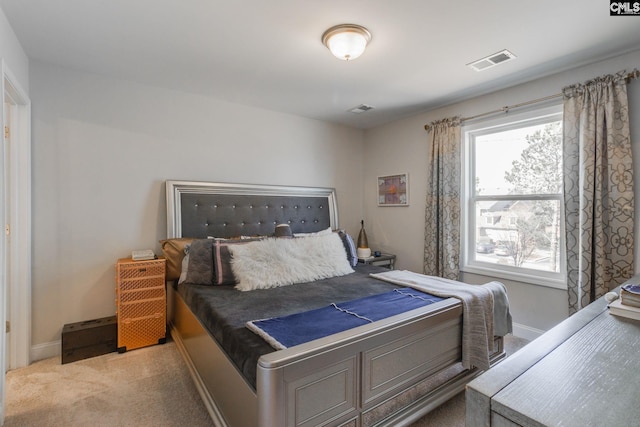 bedroom featuring light carpet, visible vents, and baseboards