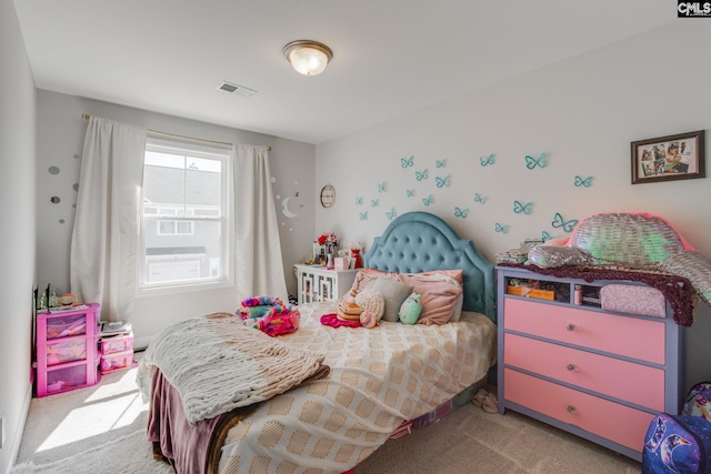 carpeted bedroom featuring visible vents