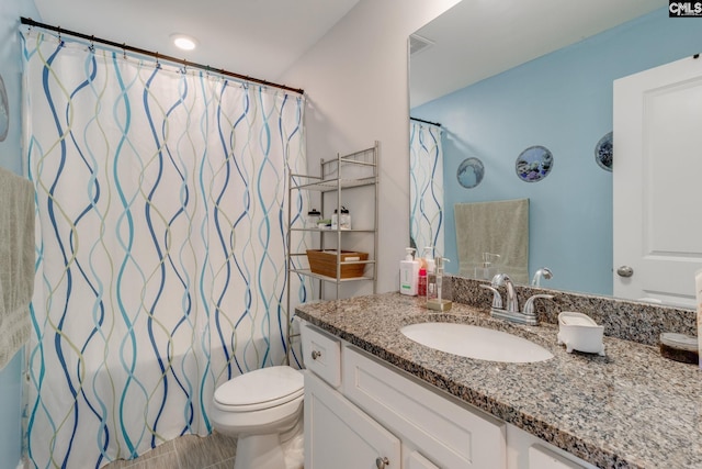 full bathroom with toilet, a shower with curtain, and vanity