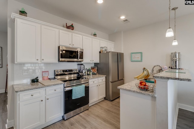 kitchen featuring white cabinetry, visible vents, and appliances with stainless steel finishes