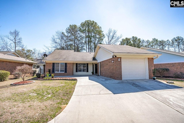 ranch-style home featuring a garage, concrete driveway, brick siding, and a front lawn