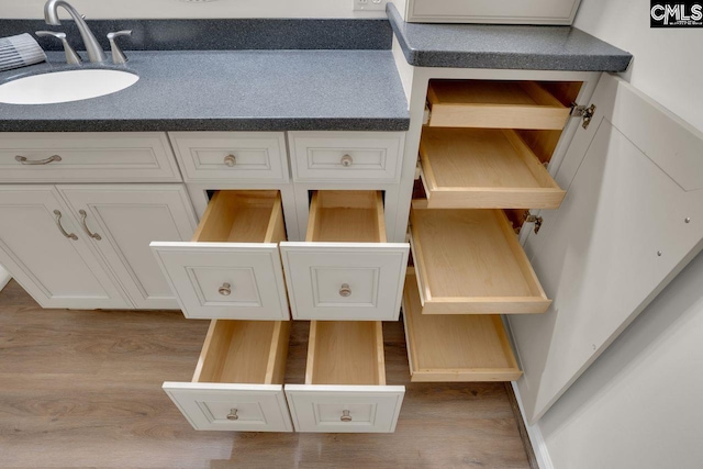 room details with wood finished floors and a sink