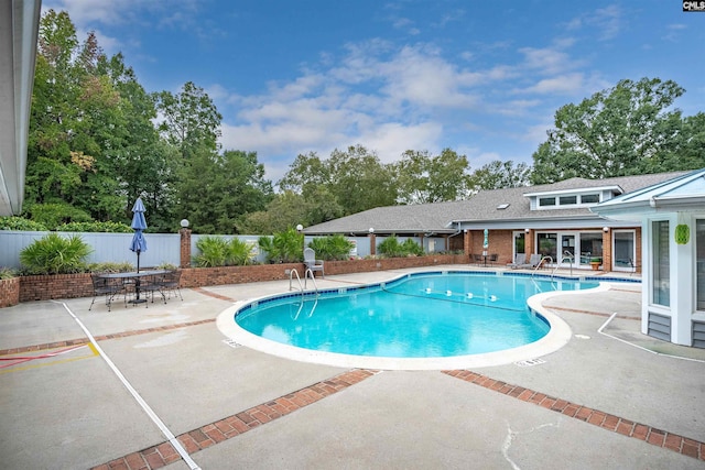 pool featuring a patio and fence