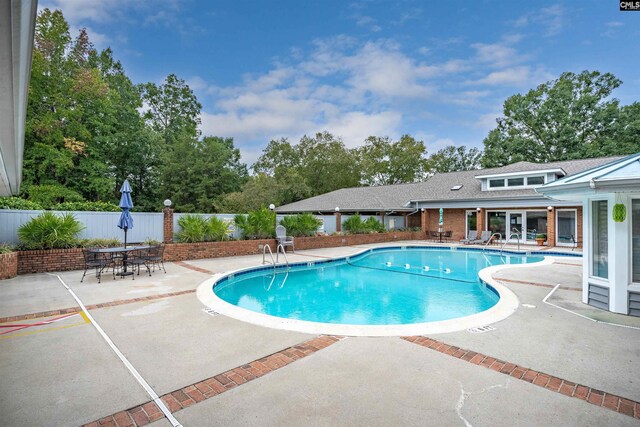 pool featuring a patio and fence