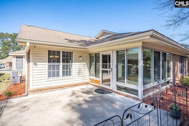 rear view of house with a patio and a sunroom