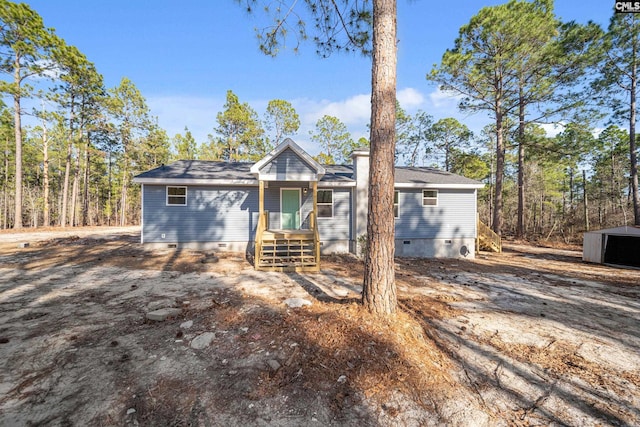 view of front of home with an outbuilding and crawl space