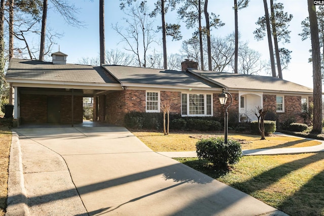 ranch-style house featuring driveway, a chimney, a front lawn, a carport, and brick siding