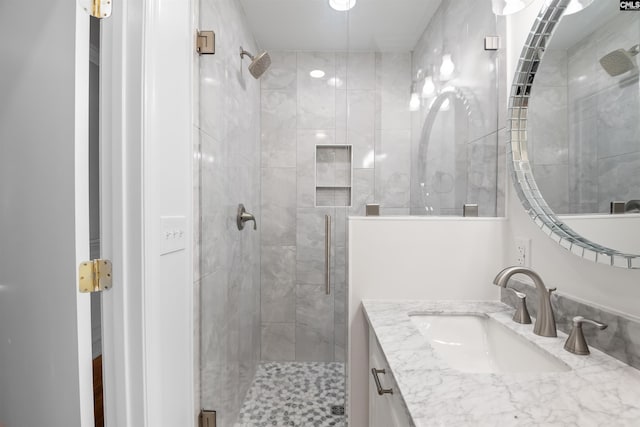 full bathroom with a shower stall and vanity