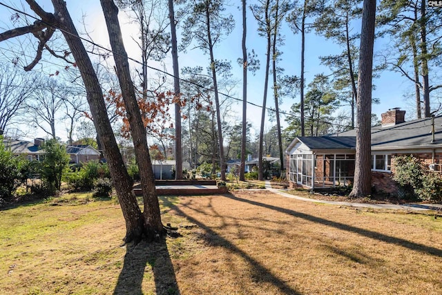 view of yard with a sunroom