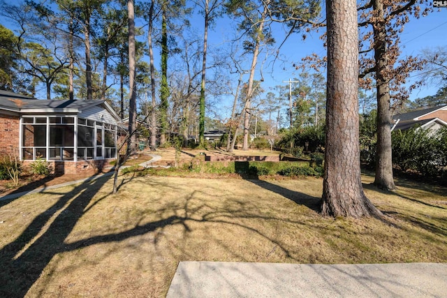 view of yard featuring a sunroom