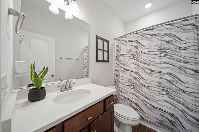 full bath featuring a shower with curtain, vanity, toilet, and wood finished floors