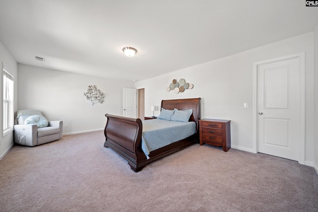 bedroom featuring carpet floors, visible vents, and baseboards