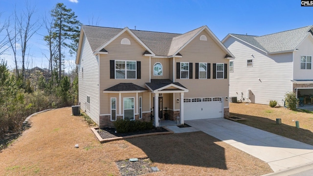 view of front of home featuring a garage, stone siding, driveway, and central AC unit