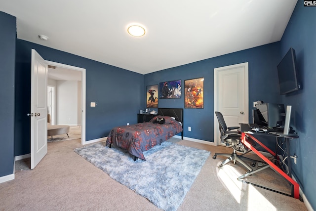 bedroom featuring carpet and baseboards