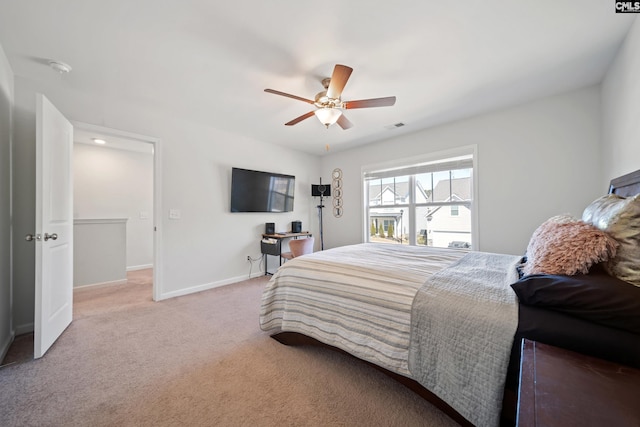 bedroom featuring baseboards, a ceiling fan, visible vents, and light colored carpet