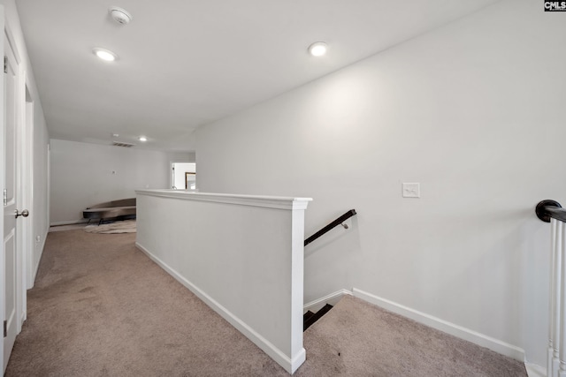 corridor featuring recessed lighting, carpet, an upstairs landing, and baseboards