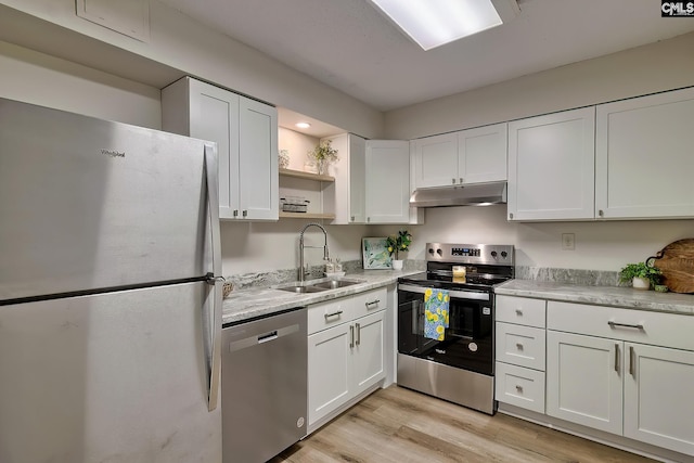 kitchen with under cabinet range hood, stainless steel appliances, a sink, white cabinets, and open shelves