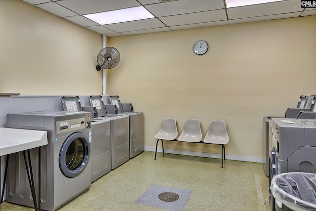 shared laundry area featuring baseboards and separate washer and dryer