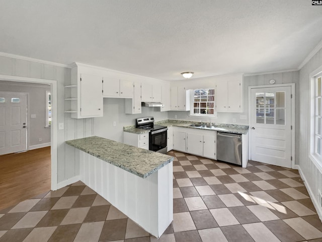 kitchen featuring a peninsula, appliances with stainless steel finishes, dark floors, and white cabinets