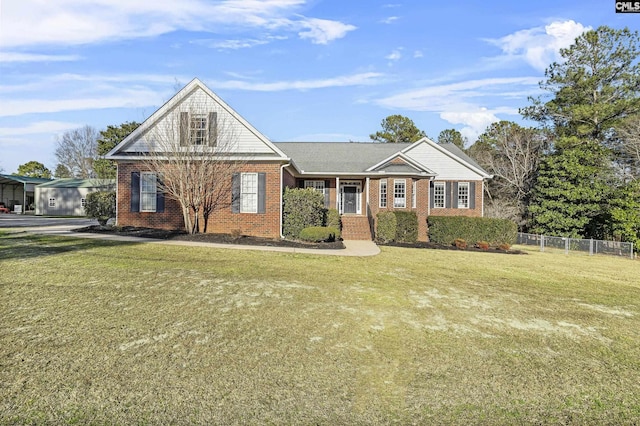 view of front of property featuring a front yard, fence, and brick siding