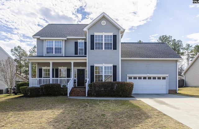 view of front of home featuring a garage, driveway, a front lawn, and a porch