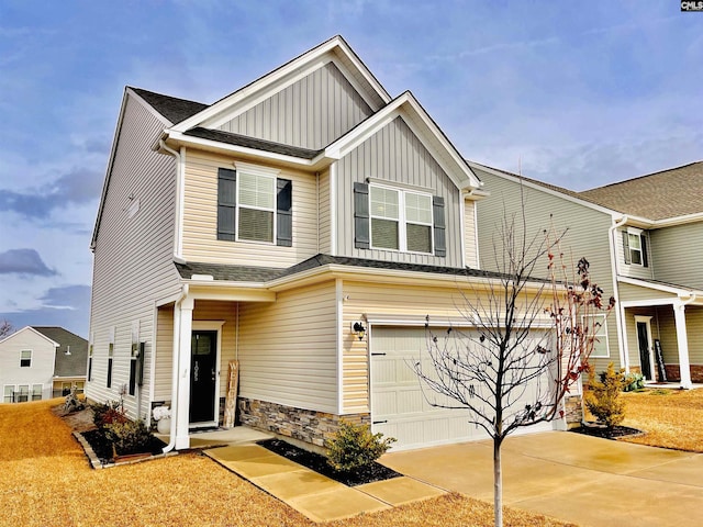 craftsman-style home with an attached garage, a shingled roof, stone siding, concrete driveway, and board and batten siding