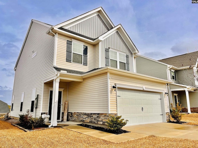 craftsman inspired home featuring stone siding, board and batten siding, and concrete driveway