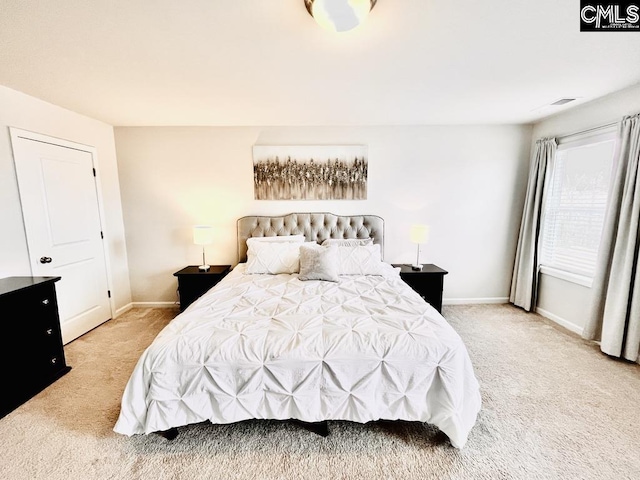 bedroom featuring light colored carpet and baseboards