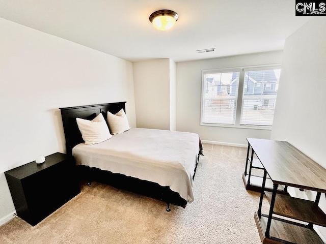 bedroom with carpet floors, visible vents, and baseboards