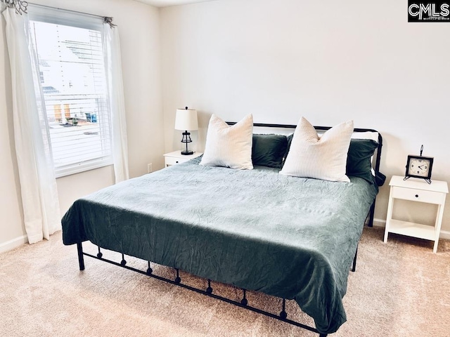 carpeted bedroom with baseboards