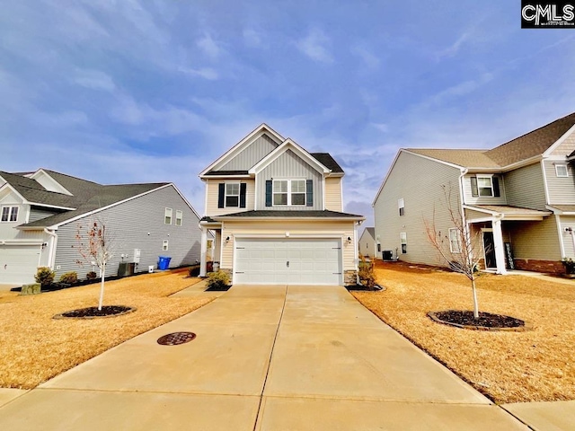 view of front of home featuring board and batten siding, cooling unit, concrete driveway, and a garage