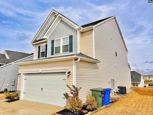 view of home's exterior with board and batten siding, driveway, an attached garage, and central air condition unit