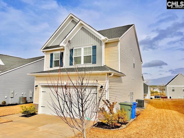 craftsman house featuring board and batten siding, cooling unit, driveway, and a garage