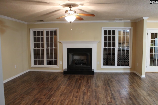 unfurnished living room with a fireplace with raised hearth, a textured ceiling, wood finished floors, visible vents, and crown molding