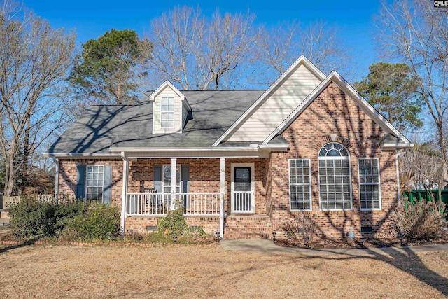 view of front facade featuring crawl space, a front yard, a porch, and brick siding