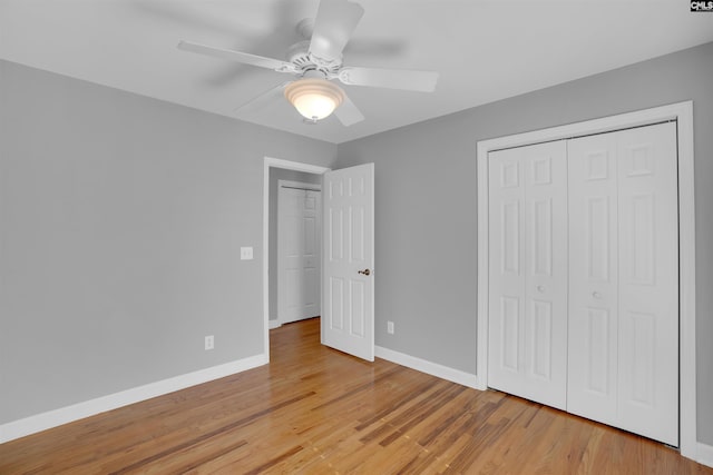 unfurnished bedroom with a closet, light wood-style flooring, and baseboards