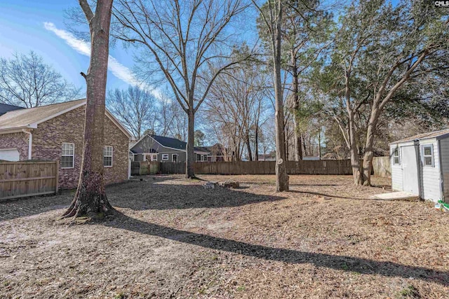 view of yard with an outbuilding and a fenced backyard