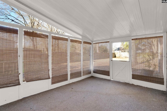 unfurnished sunroom featuring vaulted ceiling