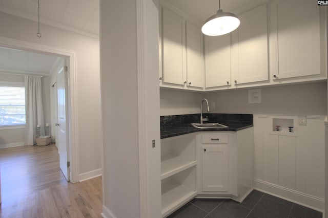 laundry area with cabinet space, ornamental molding, dark wood-style flooring, hookup for a washing machine, and a sink