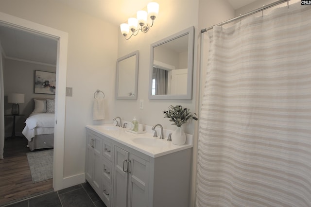 bathroom featuring ornamental molding, tile patterned flooring, a sink, and double vanity